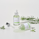 IUNIK Tea Tree Relief Serum (50ml) with texture shot with a spilt bottle of the tea tree relief serum